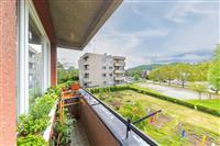 Balkon s keramickou dlažbou nabízí výhled na udržovanou zahradu a okolní zelené plochy. Vhodný pro relaxaci v klidné lokalitě.